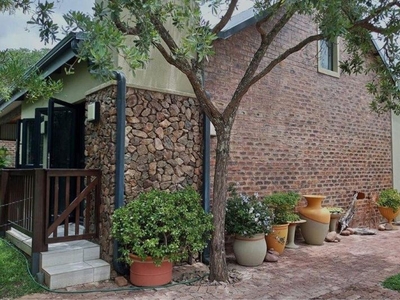 Neat and private two-bedroom corner house with lovely garden situated in up-market bushveld estate.